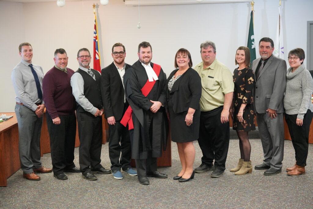 Members of Municipal Council standing in Council Chambers with the judge